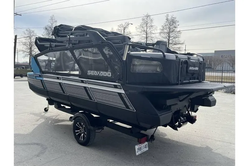 Slide: The Image of 2022 Sea Doo Switch 18 pontoon boat on trailer, parked outdoors. - 11