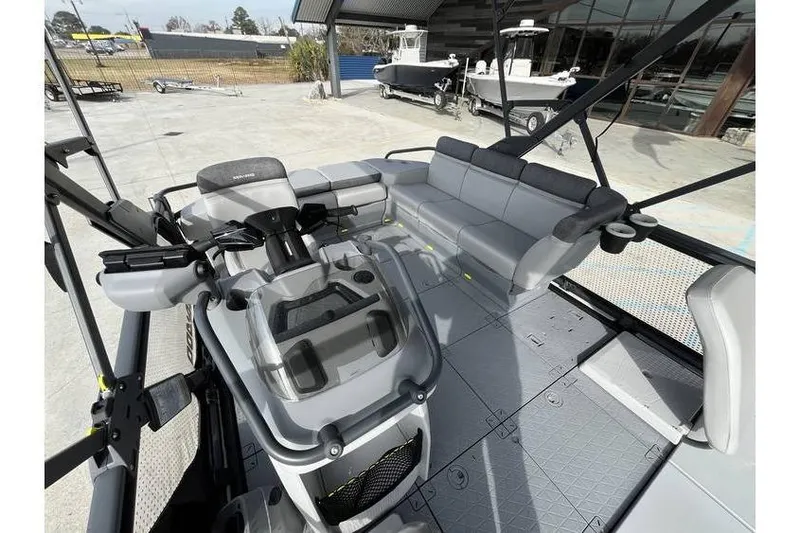 Slide: The Image of 2022 Sea Doo Switch 18 pontoon boat interior with seating and steering console. - 17