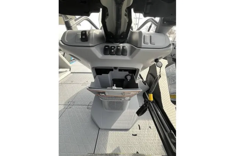 Slide: The Image of 2022 Sea Doo Switch 18 dashboard with storage compartment and controls. - 19