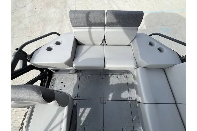 Slide: The Image of 2022 Sea Doo Switch 18 interior seating with cup holders, gray upholstery. - 21