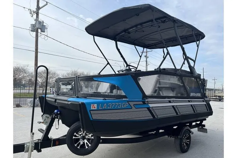 Slide: The Image of 2022 Sea Doo Switch 18 pontoon boat on trailer, blue and black design. - 3