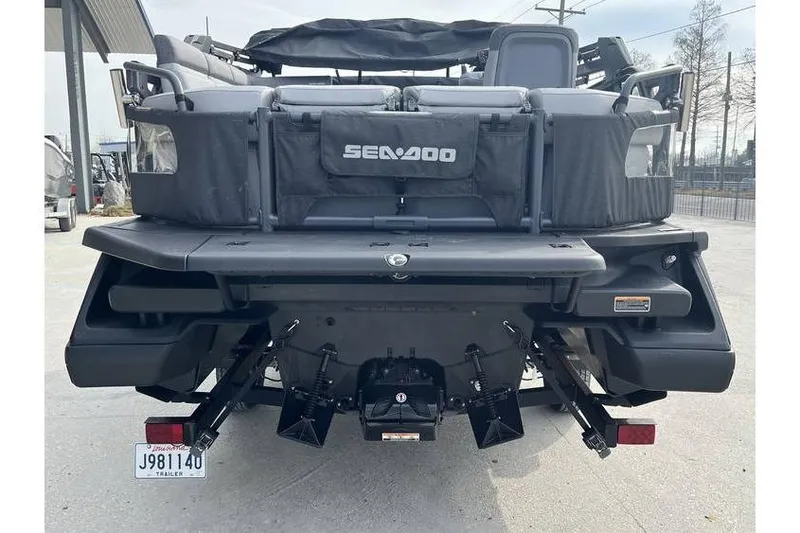 Slide: The Image of Rear view of a 2022 Sea Doo Switch 18 pontoon boat in a parking area. - 5