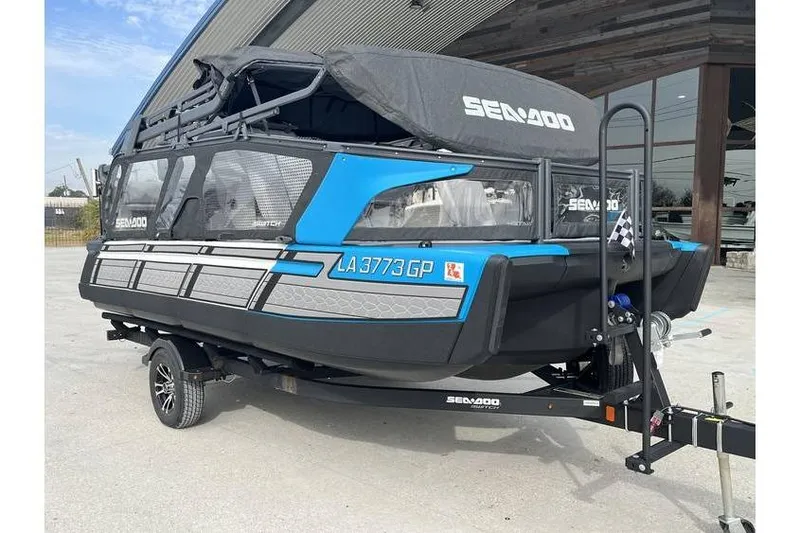 Slide: The Image of 2022 Sea Doo Switch 18 pontoon boat on trailer, blue and black design. - 7