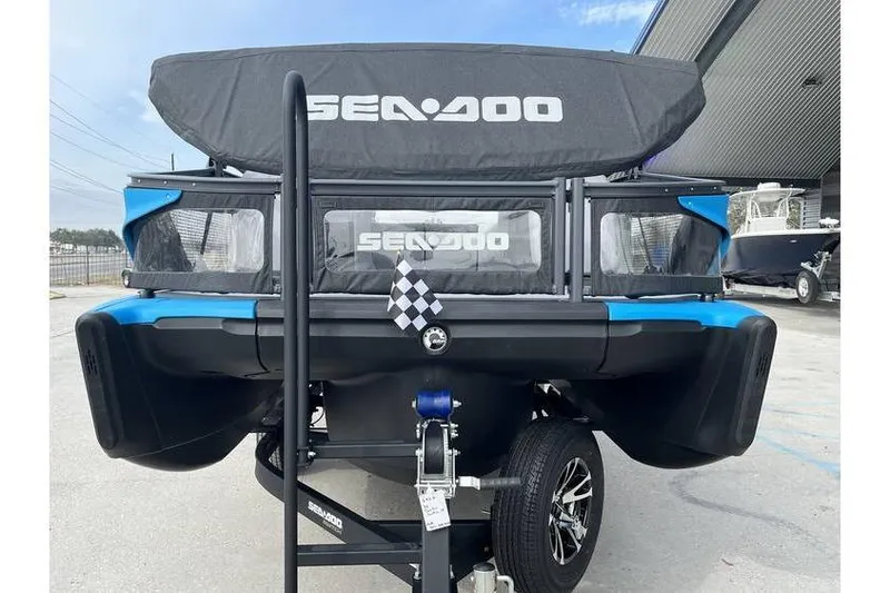 Slide: The Image of 2022 Sea Doo Switch 18 pontoon boat on trailer, rear view with cover. - 8