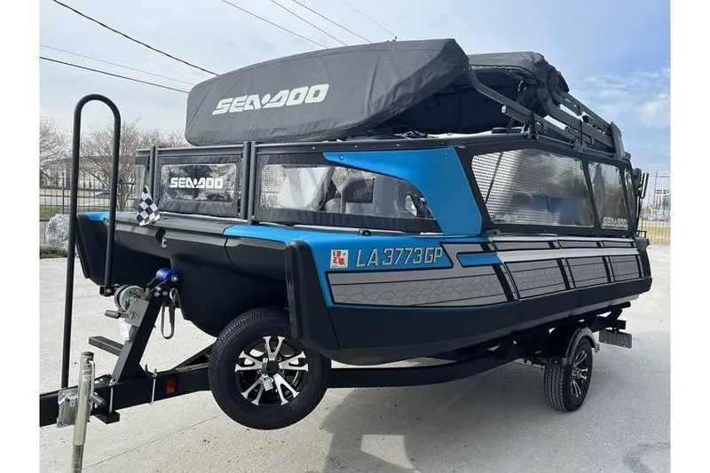 Slide: The Image of 2022 Sea Doo Switch 18 pontoon boat on trailer, featuring sleek design and vibrant blue accents. - 9