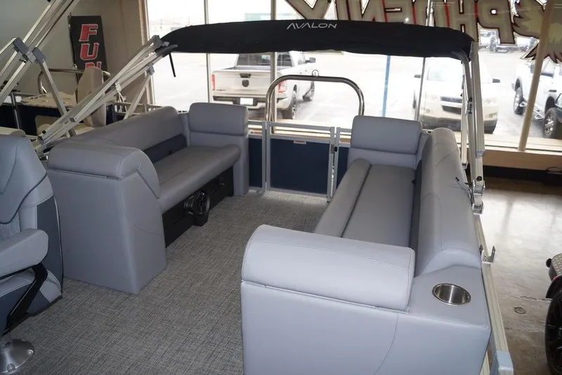Slide: The Image of 2026 Avalon VLS Quad Lounge pontoon boat interior with gray seating and canopy. - 11