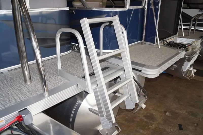 Slide: The Image of 2026 Avalon VLS Quad Lounge boat with aluminum ladder and carpeted deck. - 13