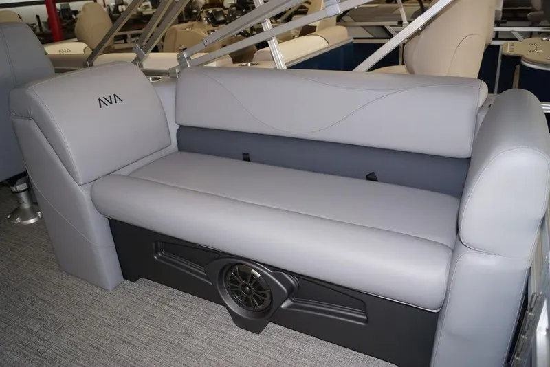 Slide: The Image of 2026 Avalon VLS Quad Lounge 21' boat interior with gray seating and speaker system. - 15