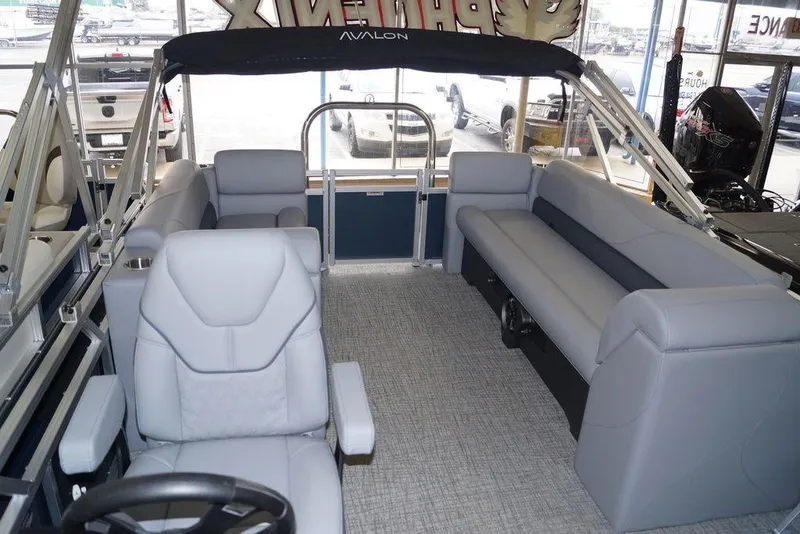 Slide: The Image of 2026 Avalon VLS Quad Lounge 21' interior with gray seating and modern design. - 9