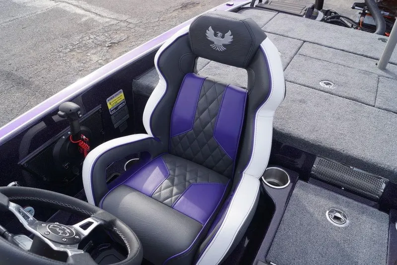 Slide: The Image of Phoenix 21 XE 2026 boat interior with purple and black seat, steering wheel, and carpeted deck. - 15