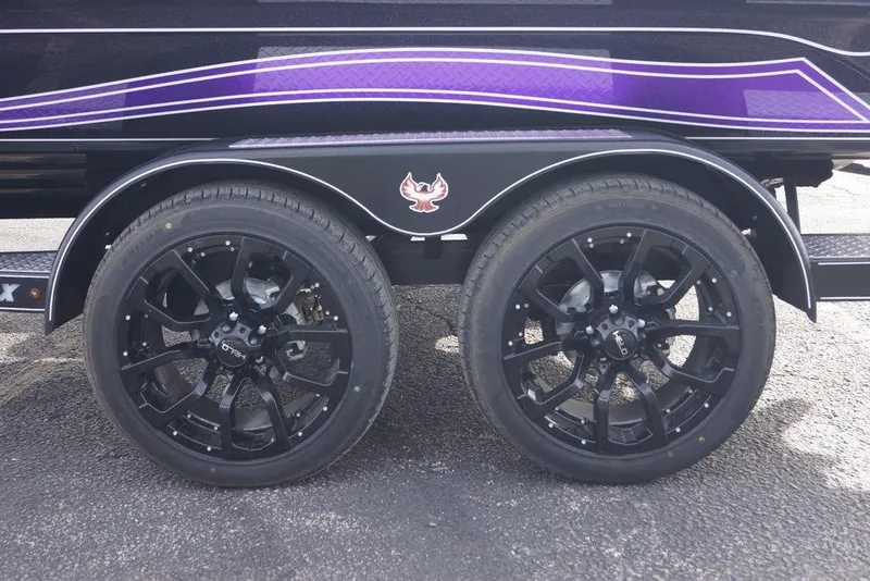 Slide: The Image of Black wheels on a 2026 Phoenix 21 XE trailer with purple detailing. - 5