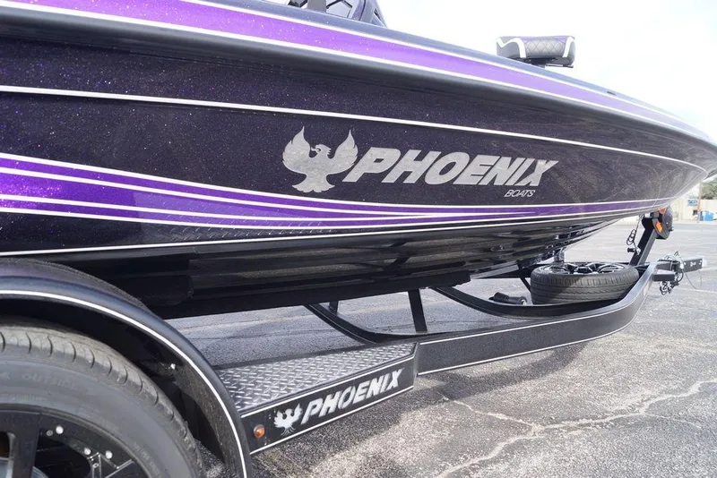 Slide: The Image of 2026 Phoenix 21 XE boat with purple accents on a trailer. - 8