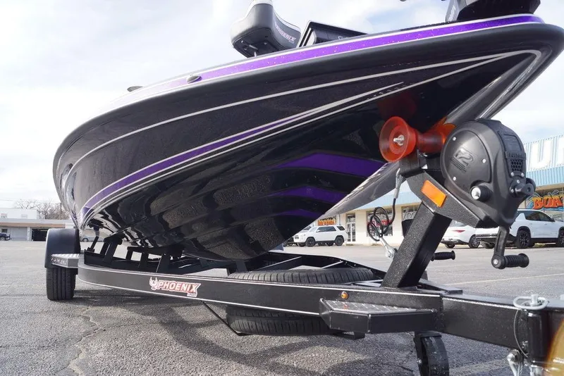 Slide: The Image of 2026 Phoenix 21 XE boat on trailer, showcasing sleek black and purple design. - 9