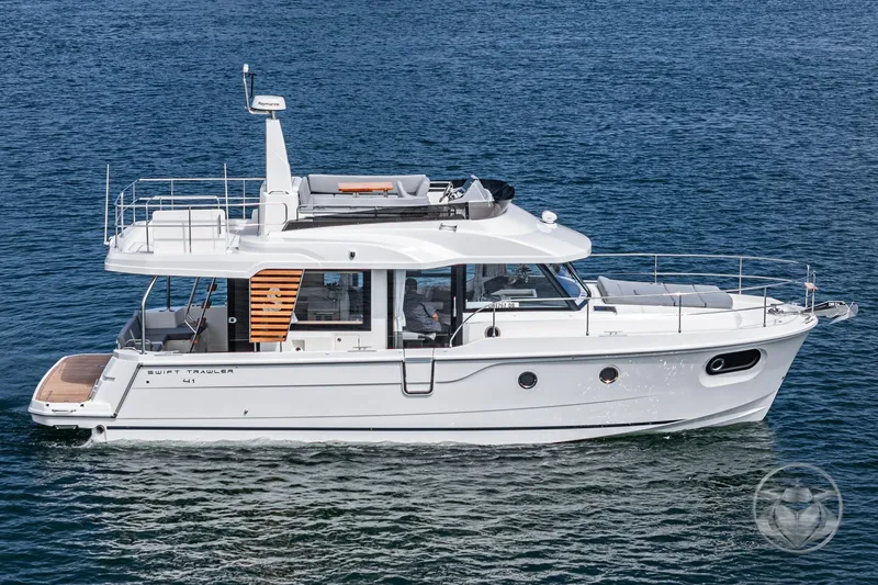 Slide: The Image of 2026 Beneteau Swift Trawler 41 Fly cruising on open water, side view. - 18
