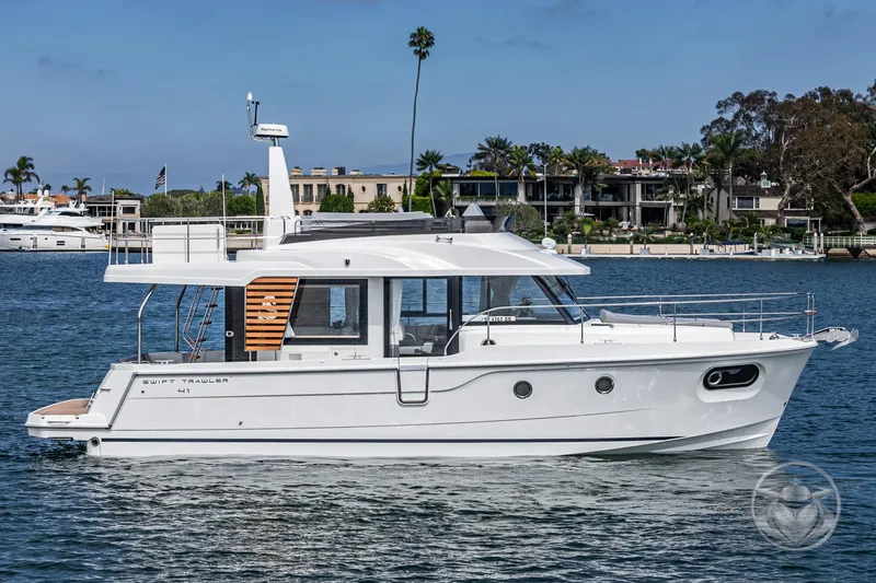 Slide: The Image of 2026 Beneteau Swift Trawler 41 Fly cruising on a scenic waterfront. - 20