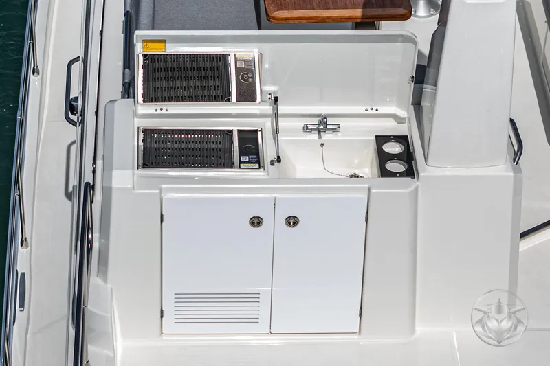 Slide: The Image of Outdoor kitchen on 2026 Beneteau Swift Trawler 41 Fly, featuring grill and sink. - 26