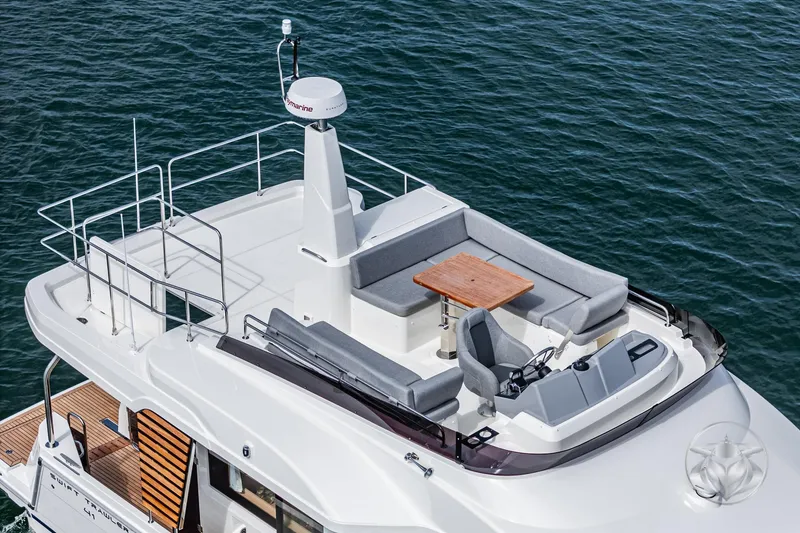 Slide: The Image of 2026 Beneteau Swift Trawler 41 Fly, flybridge view, with seating and helm station. - 32