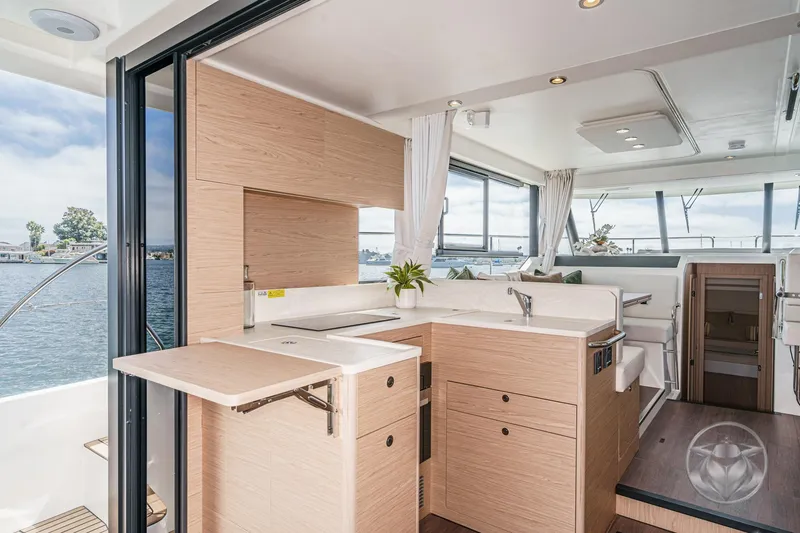 Slide: The Image of Modern interior of 2026 Beneteau Swift Trawler 41 Fly with open kitchen and scenic view. - 4
