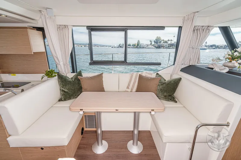 Slide: The Image of Interior of 2026 Beneteau Swift Trawler 41 Fly with elegant seating and scenic water view. - 54