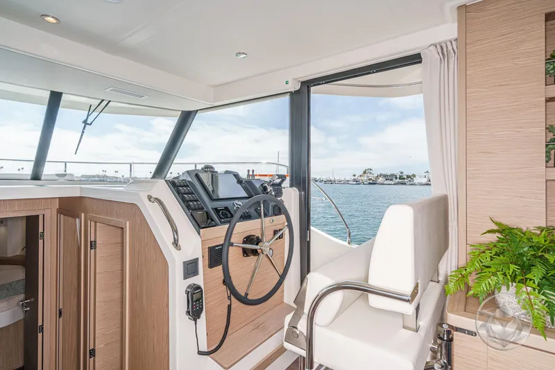 Slide: The Image of Interior of 2026 Beneteau Swift Trawler 41 Fly, featuring helm and ocean view. - 56
