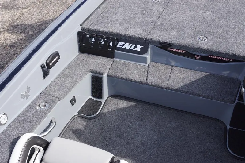 Slide: The Image of Interior of 2026 Phoenix 819 ZXL boat with gray carpet and storage compartments. - 16
