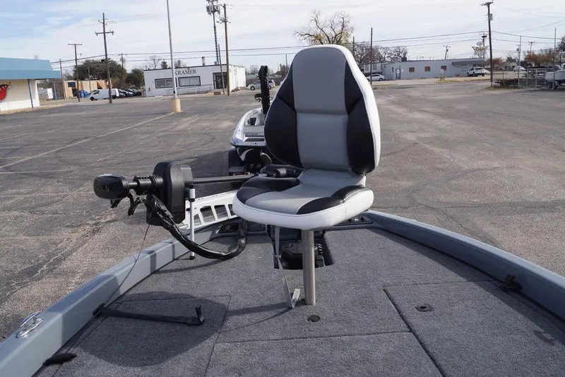 Slide: The Image of 2026 Phoenix 819 ZXL boat with swivel seat and trolling motor in parking lot. - 19