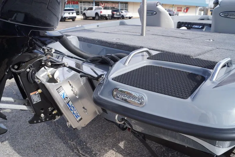 Slide: The Image of 2026 Phoenix 819 ZXL boat with motor and deck details in a parking lot. - 6