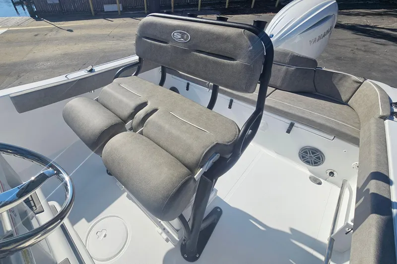 Slide: The Image of 2026 Sea Hunt Ultra 229 boat interior with cushioned seating and steering wheel. - 10