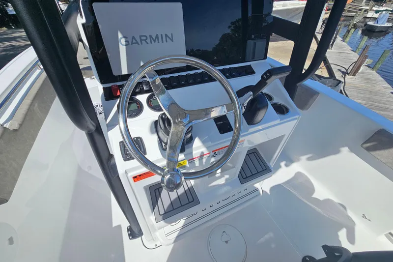 Slide: The Image of 2026 Sea Hunt Ultra 229 boat console with Garmin navigation system and steering wheel. - 11