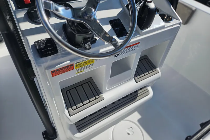 Slide: The Image of Steering console of 2026 Sea Hunt Ultra 229 boat with controls and footrests. - 12