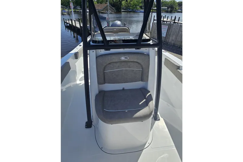 Slide: The Image of 2026 Sea Hunt Ultra 229 boat interior with cushioned seating and console. - 23