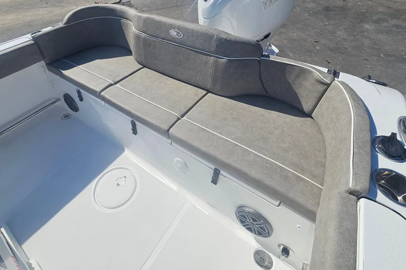 Slide: The Image of 2026 Sea Hunt Ultra 229 boat interior with cushioned seating and storage compartments. - 7