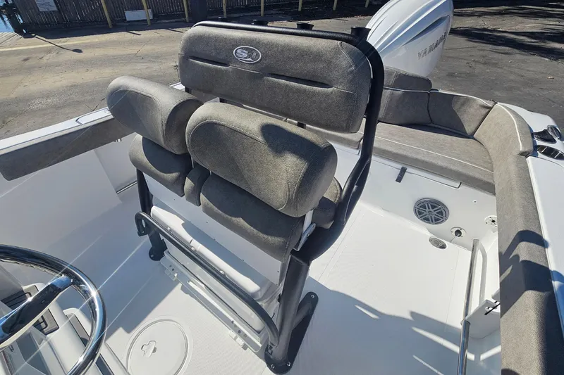 Slide: The Image of 2026 Sea Hunt Ultra 229 boat interior with cushioned seating and steering wheel. - 9