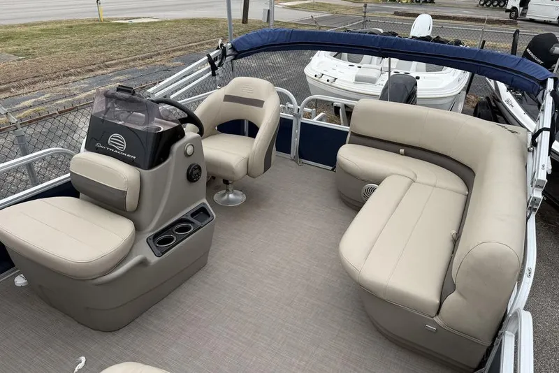 Slide: The Image of Interior of a 2026 Phoenix 920 Elite X boat with beige seating and steering console. - 11