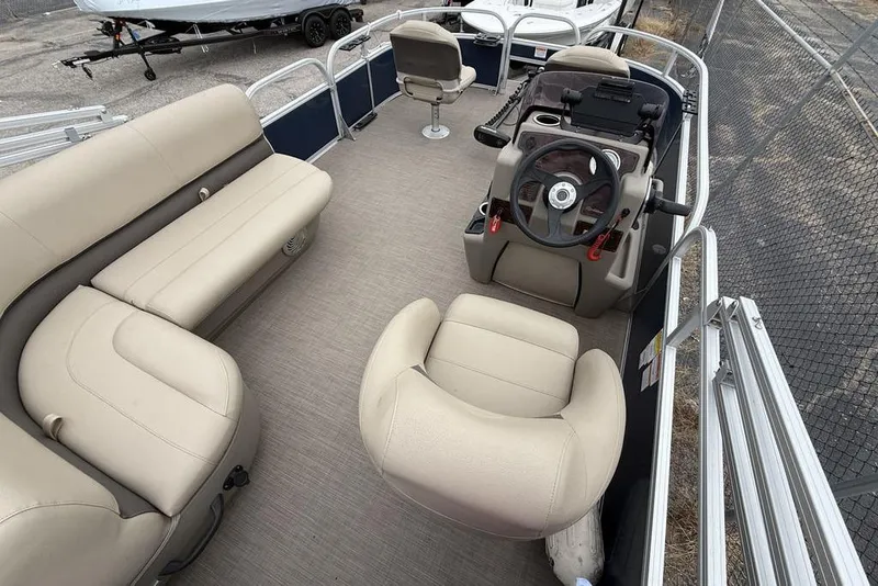 Slide: The Image of 2026 Phoenix 920 Elite X boat interior with beige seating and steering console. - 14