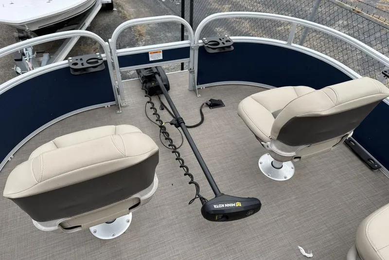 Slide: The Image of Phoenix 920 Elite X 2026 boat interior with two beige seats and trolling motor. - 6