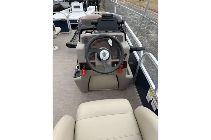 Slide: The Image of Steering console of 2026 Phoenix 920 Elite X boat with beige seating. - 9