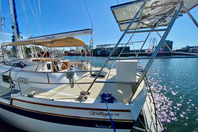 Slide: The Image of Sailboat Wellington 44, 1980 model, docked in sunny marina with clear blue skies. - 10