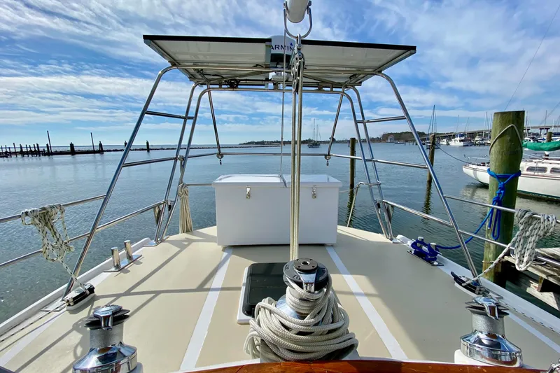 Slide: The Image of Deck view of 1980 Wellington 44 sailboat in a marina under blue skies. - 11