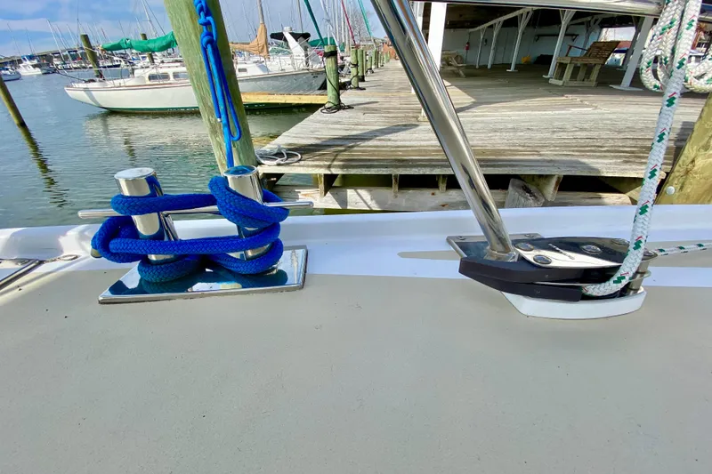 Slide: The Image of Sailboat deck with blue rope and cleat, Wellington 44, 1980 model, docked at marina. - 14