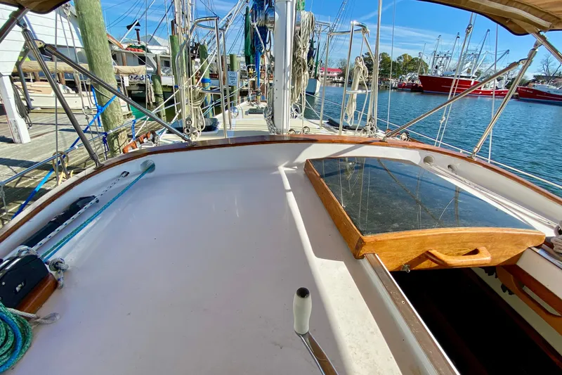 Slide: The Image of 1980 Wellington 44 sailboat deck with wooden hatch, docked at marina. - 18