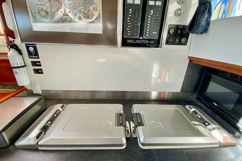 Slide: The Image of Control panel and appliances in a 1980 Wellington 44 yacht interior. - 24