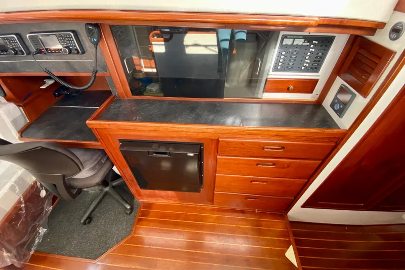 Slide: The Image of 1980 Wellington 44 yacht interior with navigation station and wooden cabinetry. - 25