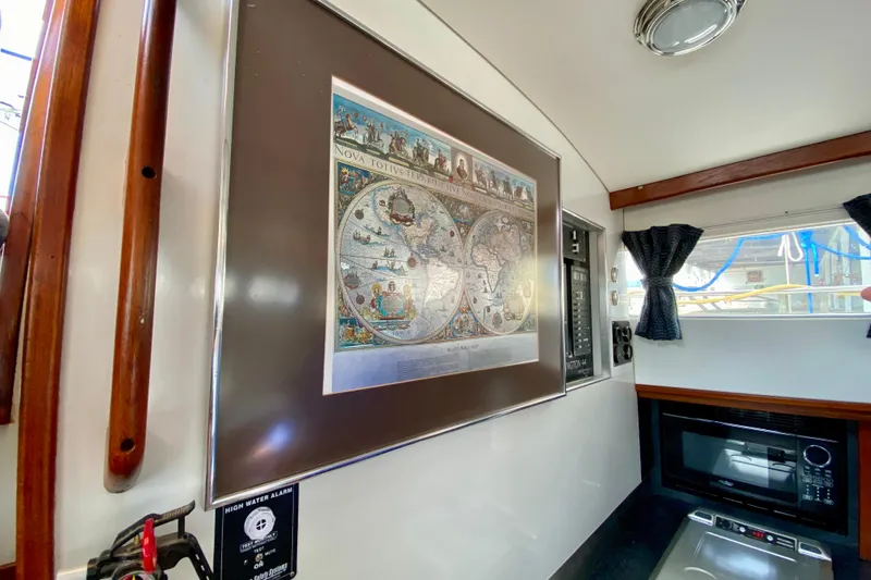 Slide: The Image of Interior of 1980 Wellington 44 yacht with vintage world map and modern appliances. - 28