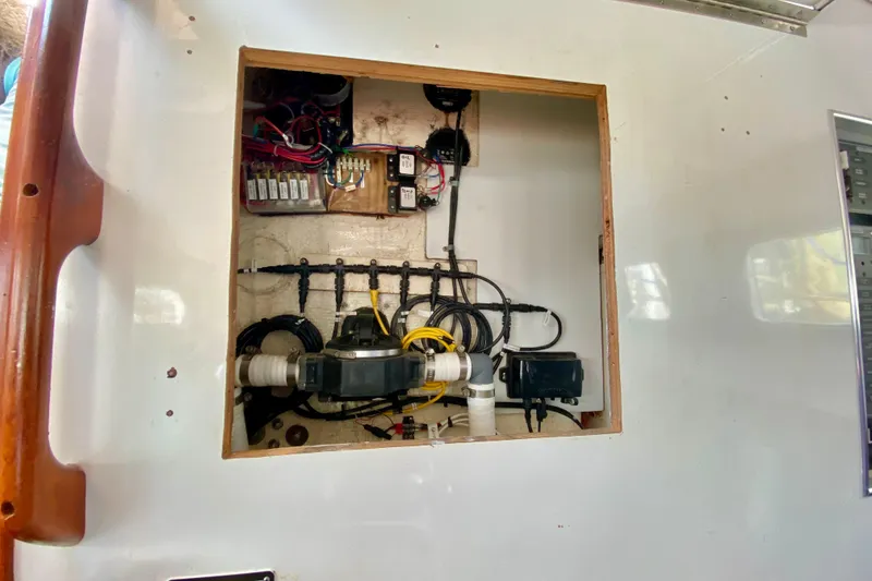 Slide: The Image of Electrical panel inside a 1980 Wellington 44 boat, showcasing wiring and components. - 29