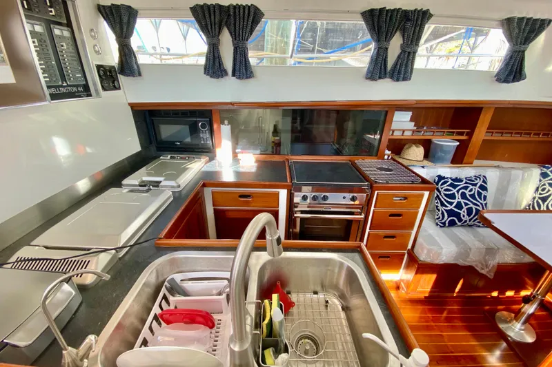 Slide: The Image of 1980 Wellington 44 yacht kitchen with modern appliances and wooden cabinetry. - 34