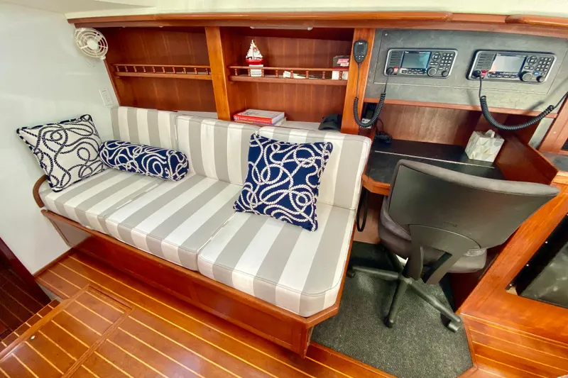 Slide: The Image of Cozy interior of 1980 Wellington 44 yacht with striped seating and navigation equipment. - 35
