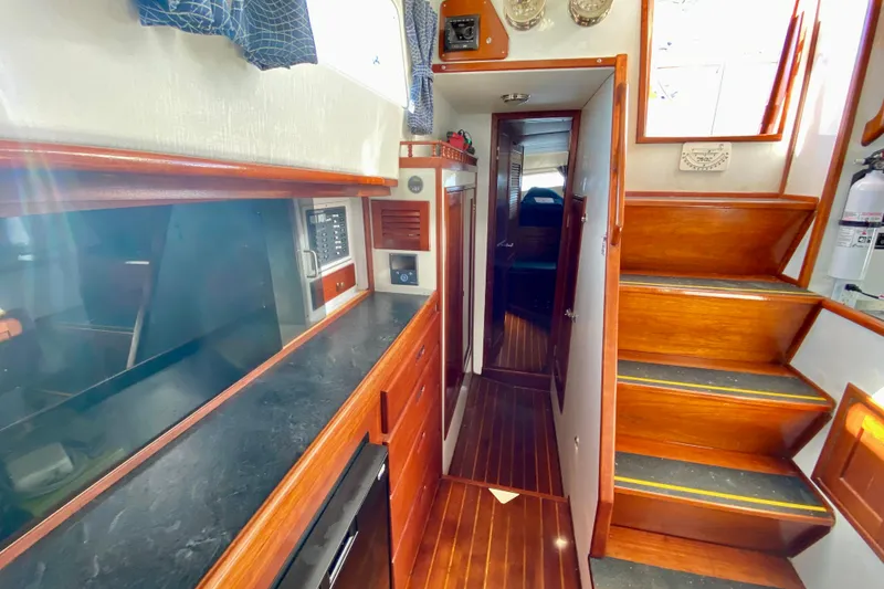 Slide: The Image of Interior of 1980 Wellington 44 yacht with wooden finishes and modern amenities. - 37