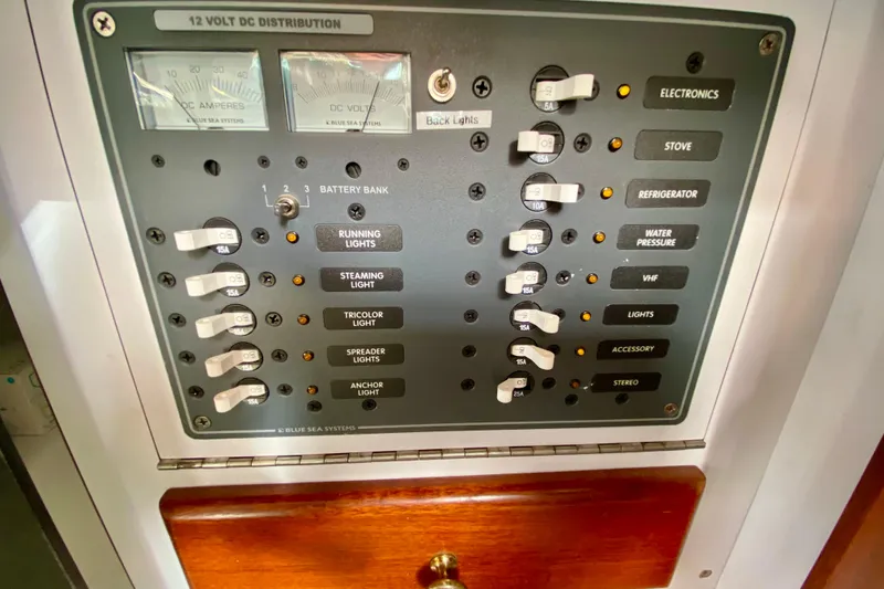 Slide: The Image of Electrical panel of a 1980 Wellington 44 boat with various switches and gauges. - 38