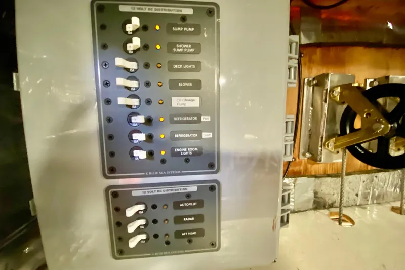 Slide: The Image of Electrical panel on a 1980 Wellington 44 boat with labeled switches and controls. - 40
